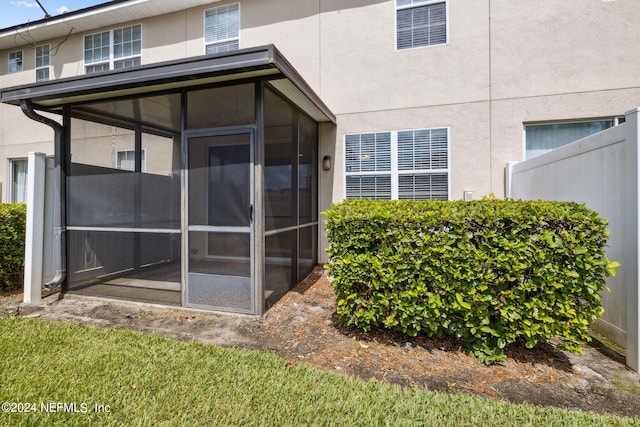 back of house featuring a sunroom