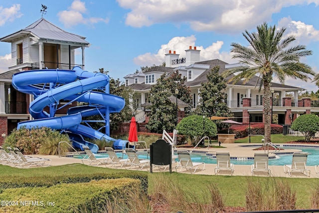 view of swimming pool featuring a patio and a water slide