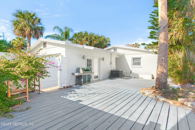 wooden terrace featuring grilling area and central AC unit