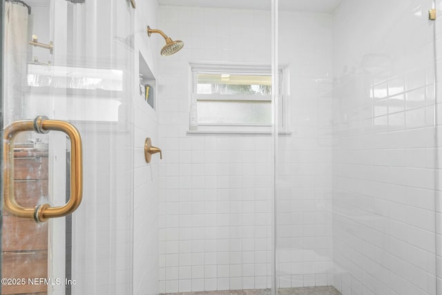 bathroom with a shower with door