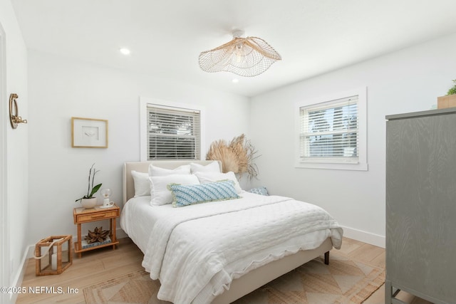 bedroom featuring multiple windows and light hardwood / wood-style floors