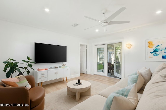 living room featuring ceiling fan, light hardwood / wood-style flooring, and ornamental molding