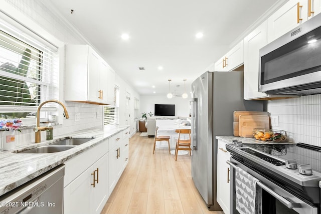 kitchen with white cabinetry, sink, and appliances with stainless steel finishes