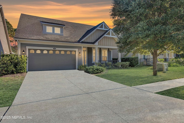 craftsman-style home with a lawn, a porch, and a garage