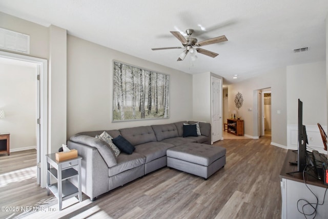 living room with ceiling fan and wood-type flooring