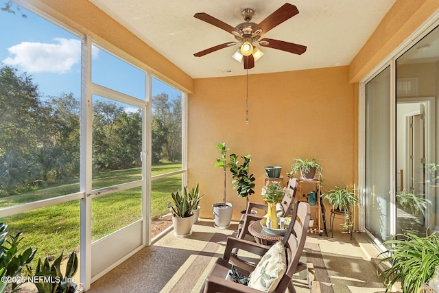 sunroom / solarium featuring ceiling fan