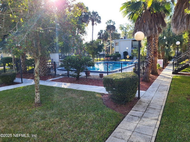 view of pool featuring a yard