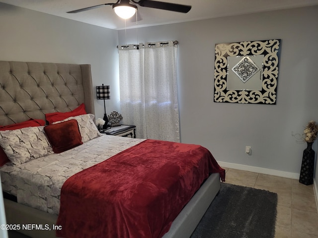 tiled bedroom featuring ceiling fan