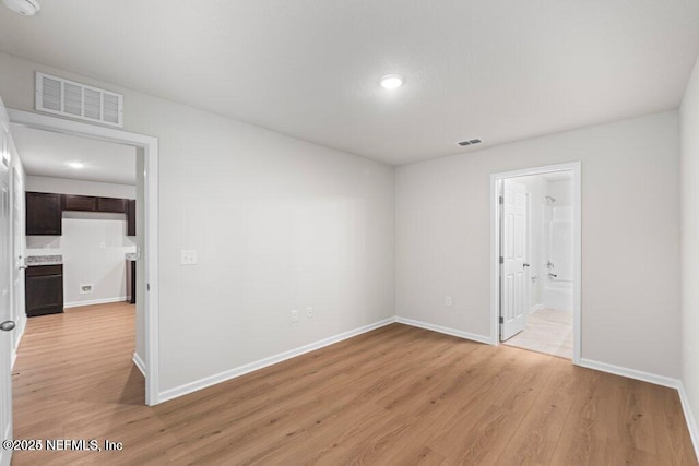 spare room featuring light hardwood / wood-style floors