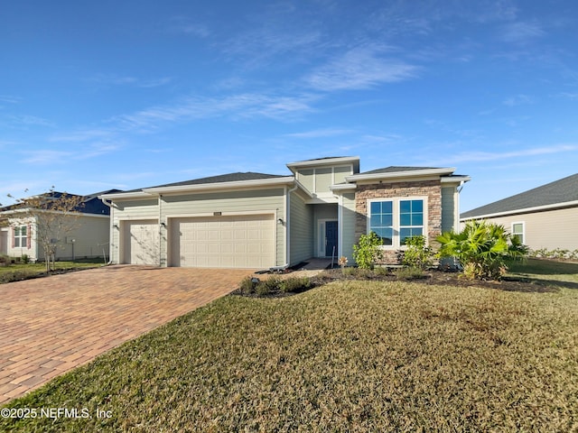 view of front of house with a garage and a front yard