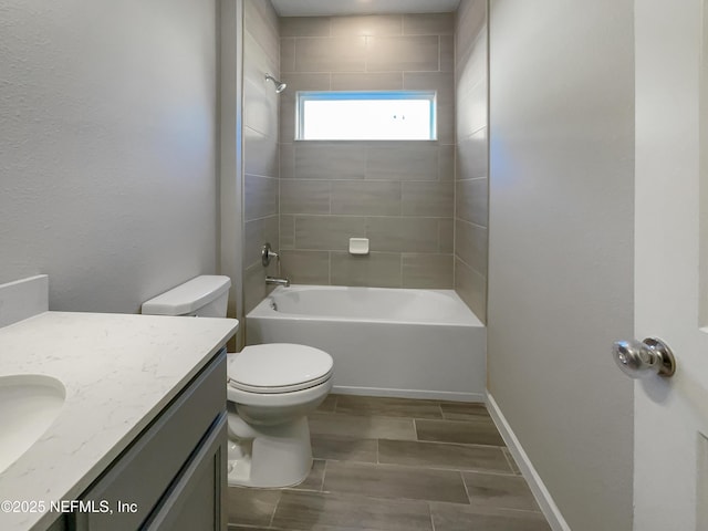 full bathroom with vanity, toilet, and tiled shower / bath