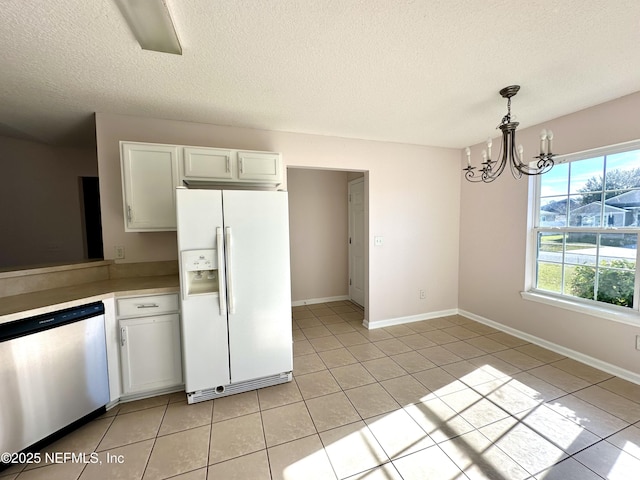 kitchen featuring dishwasher, white refrigerator with ice dispenser, hanging light fixtures, a notable chandelier, and white cabinetry