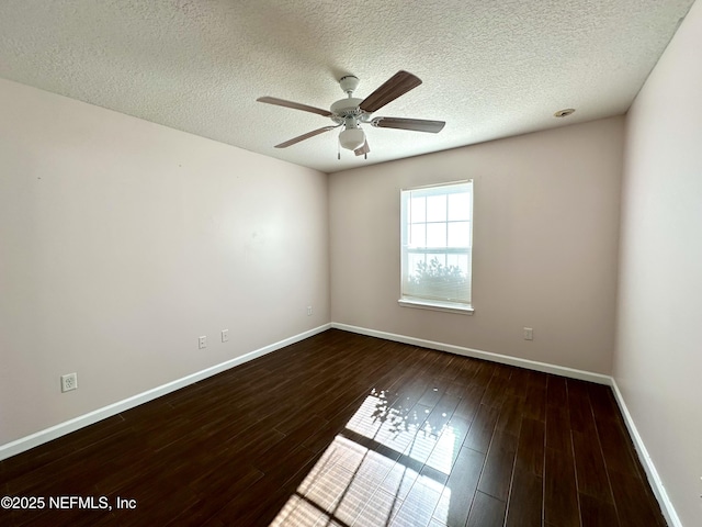 empty room with ceiling fan, dark hardwood / wood-style flooring, and a textured ceiling