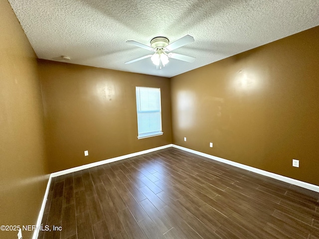 spare room featuring ceiling fan and dark wood-type flooring