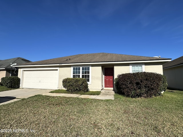 ranch-style home with a garage and a front lawn