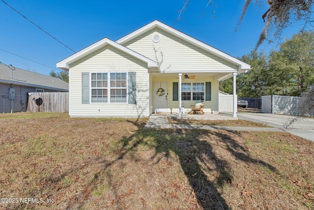 bungalow-style home with covered porch and a front lawn