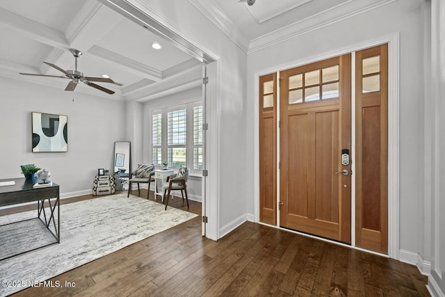 foyer featuring dark wood-type flooring, coffered ceiling, ceiling fan, ornamental molding, and beam ceiling