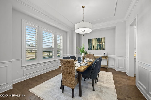 dining space featuring crown molding and dark wood-type flooring