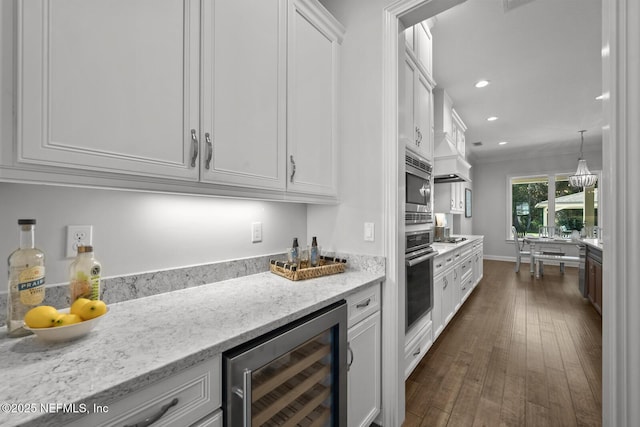 kitchen with light stone countertops, stainless steel appliances, beverage cooler, decorative light fixtures, and white cabinets