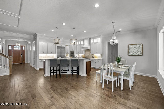 dining room with dark wood-type flooring and ornamental molding