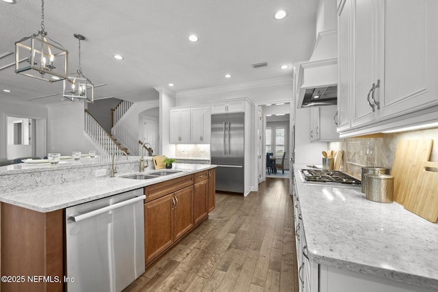 kitchen featuring white cabinetry, a center island with sink, stainless steel appliances, and sink