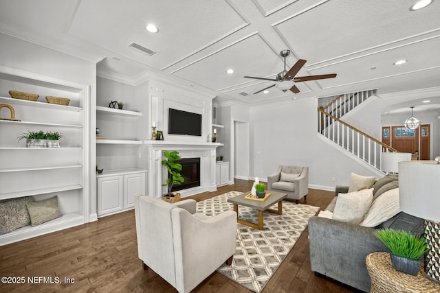 living room featuring dark hardwood / wood-style flooring, ceiling fan, and built in features