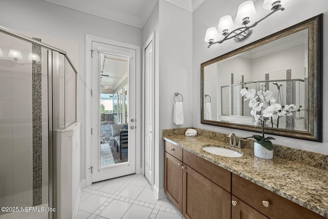 bathroom featuring tile patterned floors, crown molding, vanity, and walk in shower