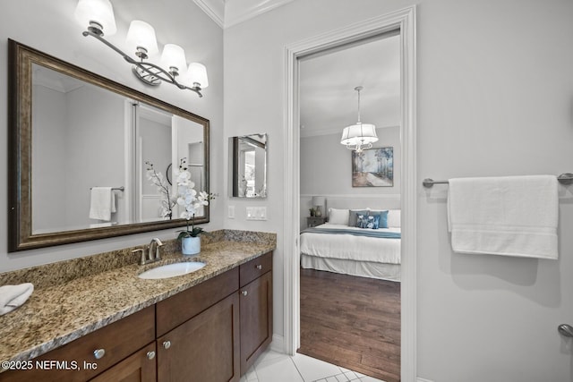 bathroom with tile patterned floors, crown molding, and vanity