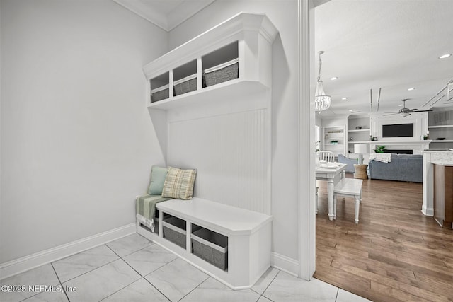 mudroom featuring built in shelves and ceiling fan