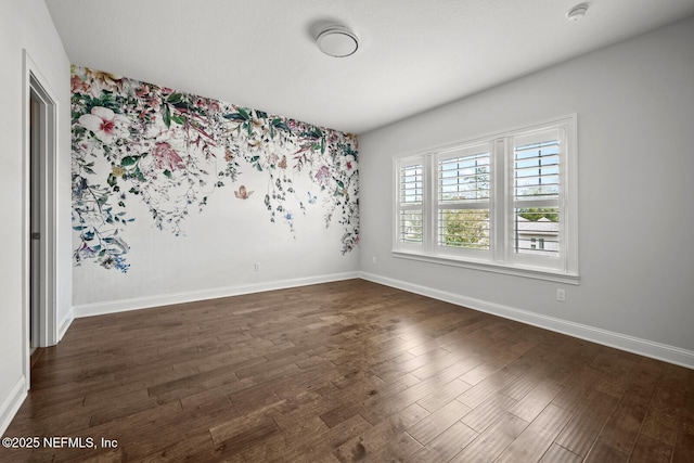 spare room featuring dark wood-type flooring