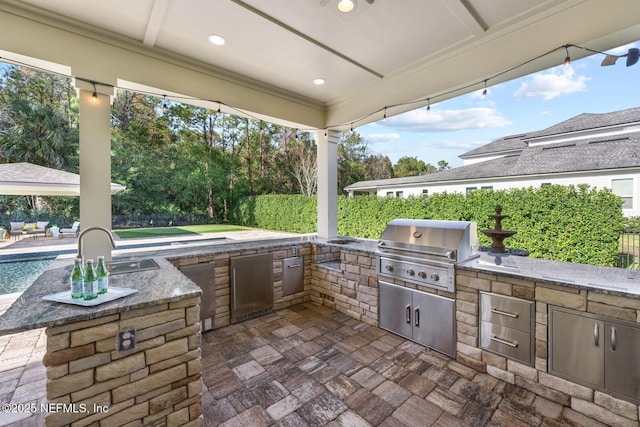 view of patio / terrace featuring area for grilling and sink