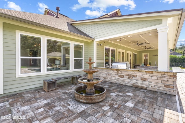 view of patio / terrace with an outdoor kitchen, ceiling fan, and grilling area