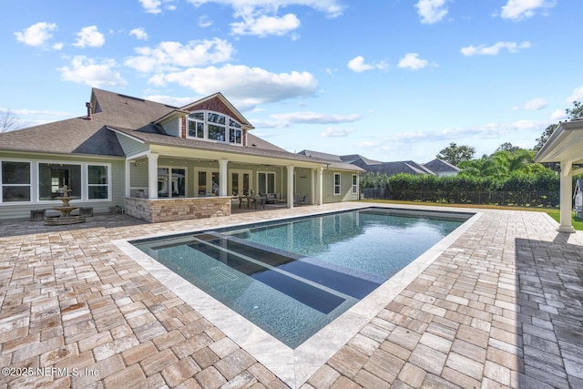 view of swimming pool featuring a patio area