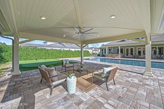 view of patio featuring ceiling fan, a fenced in pool, and an outdoor living space