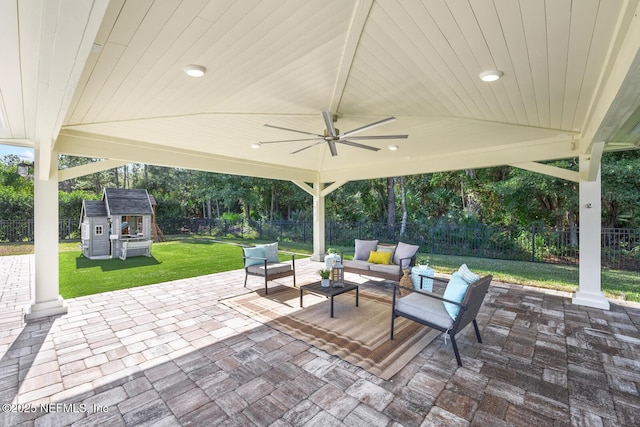 view of patio with a gazebo, an outdoor living space, a shed, and ceiling fan