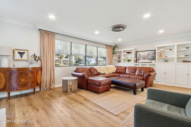 living room with light wood-type flooring and ornamental molding