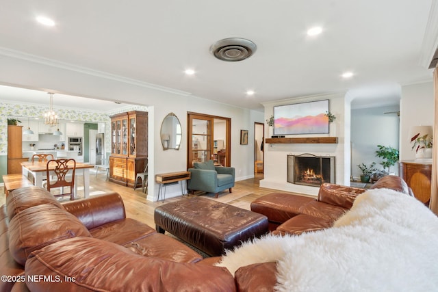 living room featuring light hardwood / wood-style flooring and crown molding