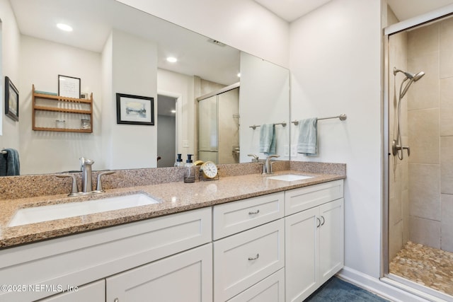 bathroom with vanity and a shower with shower door