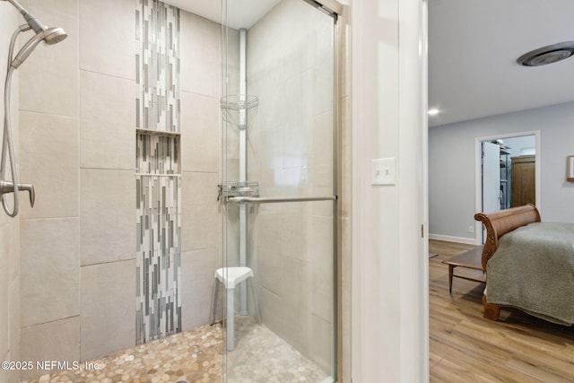 bathroom featuring hardwood / wood-style floors and walk in shower