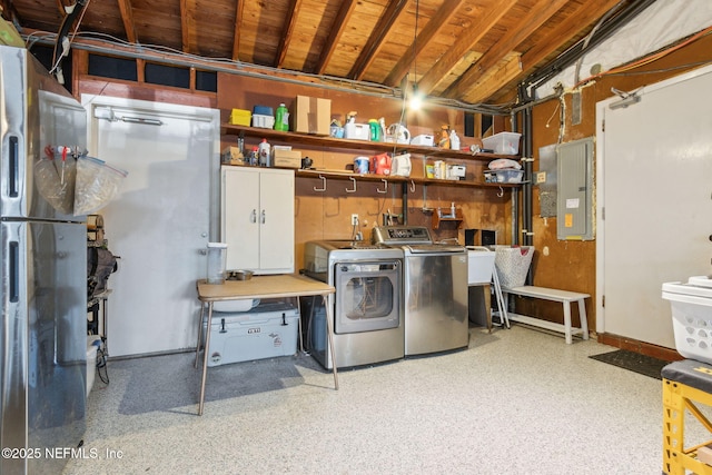 clothes washing area featuring washer and clothes dryer and electric panel