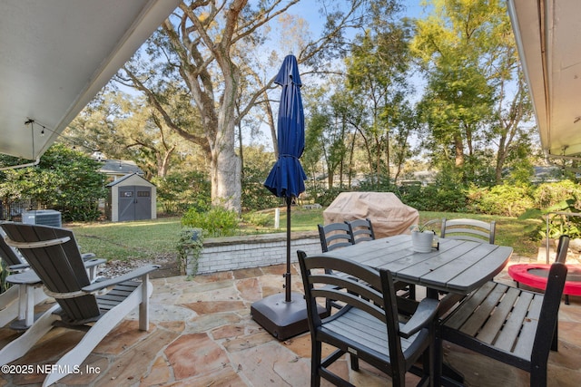 view of patio featuring a storage unit