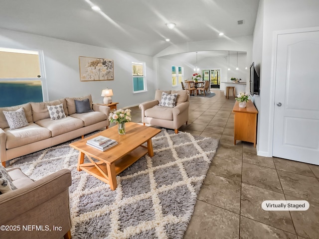 tiled living room featuring vaulted ceiling