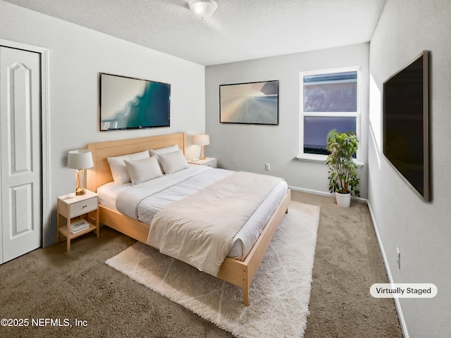 carpeted bedroom with a textured ceiling