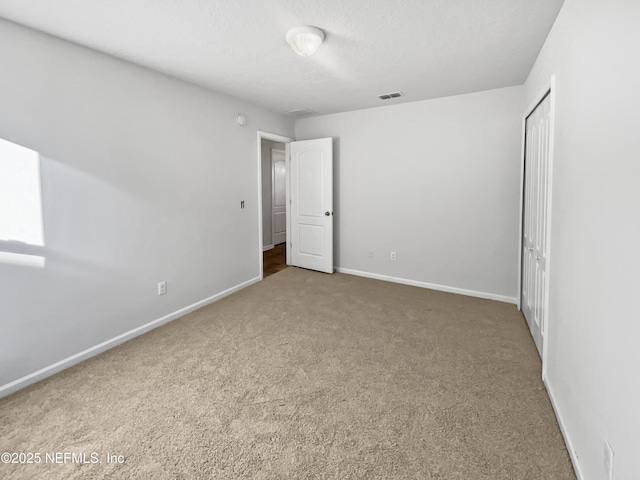 unfurnished bedroom with carpet floors and a closet