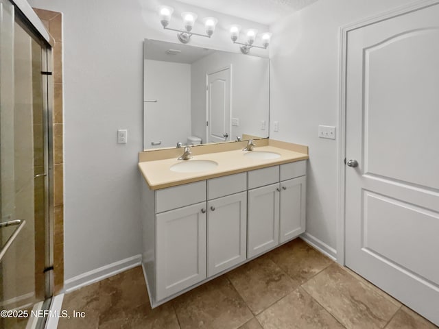 bathroom with vanity and a shower with shower door