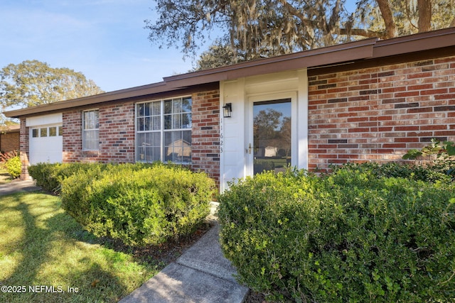 view of exterior entry with a garage