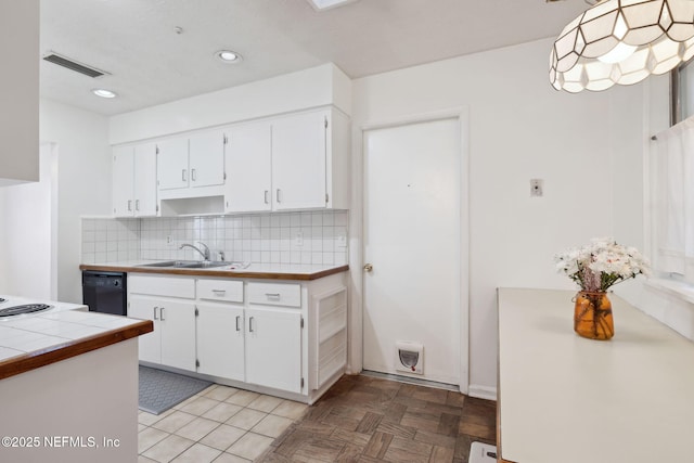 kitchen with white cabinetry, sink, black dishwasher, backsplash, and decorative light fixtures