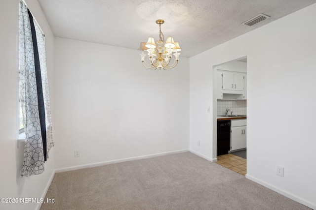 empty room with light colored carpet, plenty of natural light, a notable chandelier, and sink