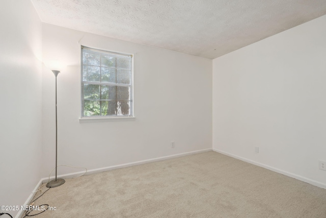 carpeted spare room featuring a textured ceiling