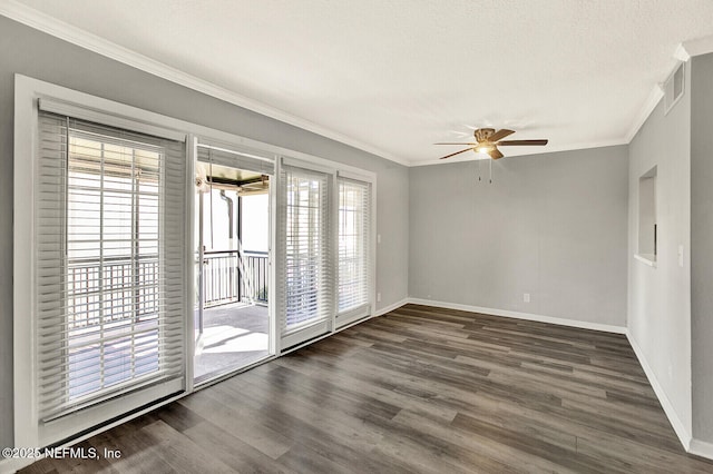 spare room with a textured ceiling, dark hardwood / wood-style floors, ceiling fan, and ornamental molding